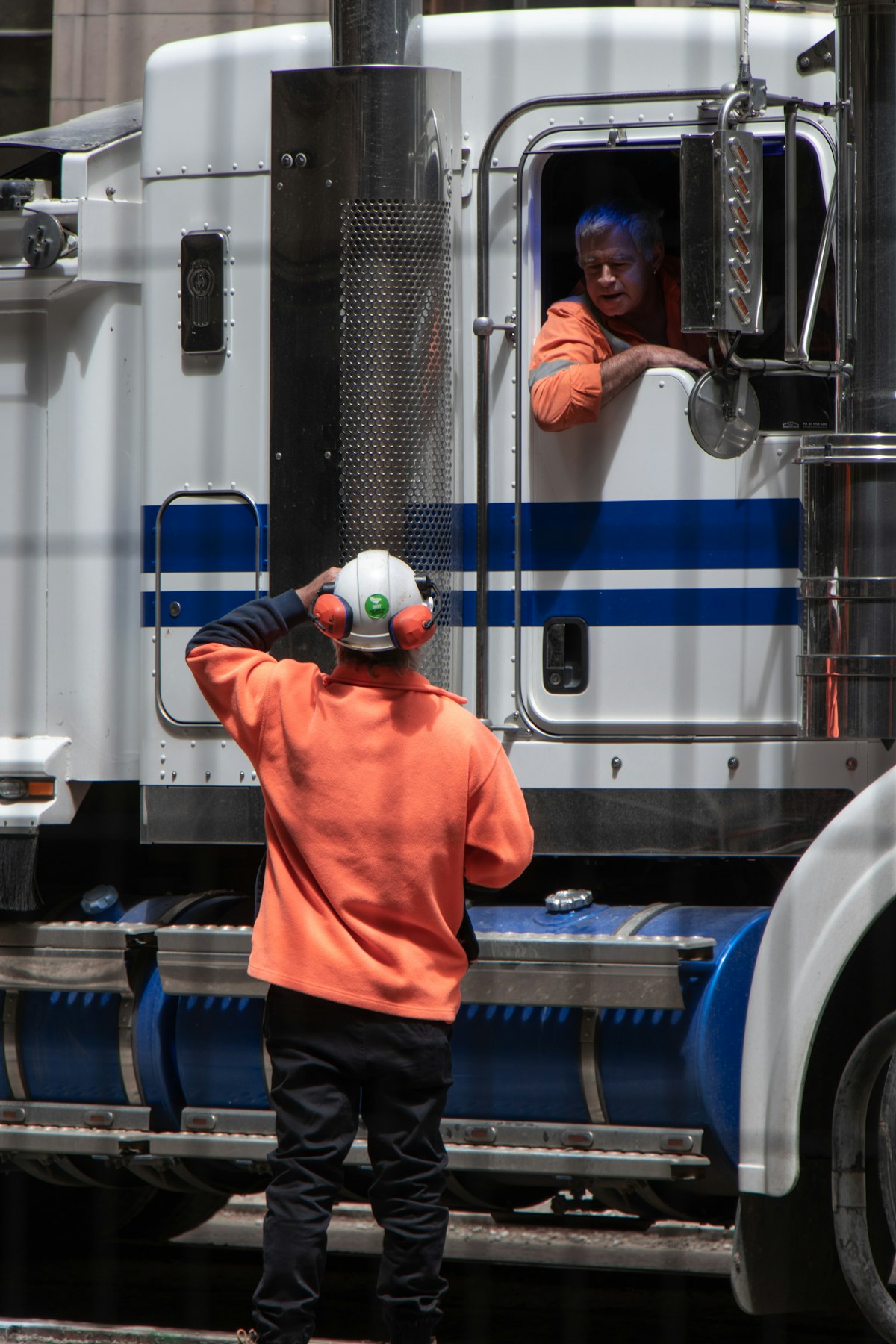 Technician with heavy-duty freight truck for mobile emission testing