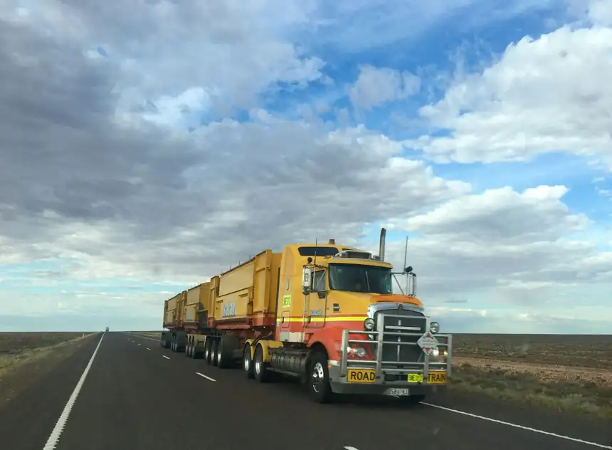 Heavy-duty road train hauling trailers on an open highway